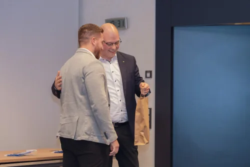 Eventfotografie Vorstandswahl: Blumenstrauß für die scheidende Vorstandsarbeit